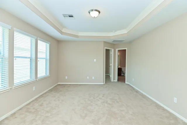 an empty room with windows and closet