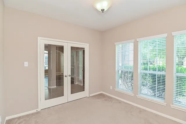 a view of an empty room with glass door