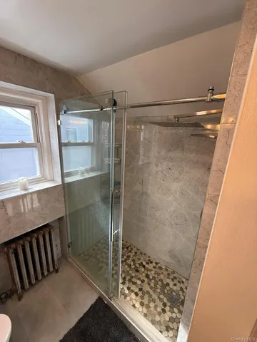 a bathroom with a shower and a sink
