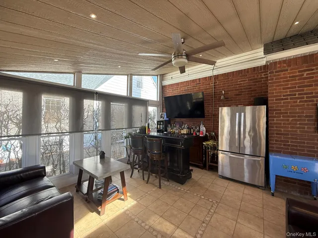 a kitchen with refrigerator and chairs