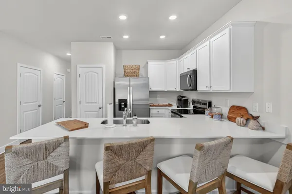 a kitchen with a sink and wooden floor