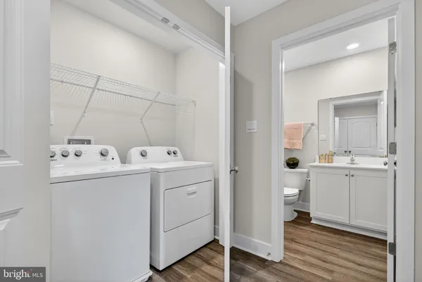 a view of a hallway with wooden floor and closet