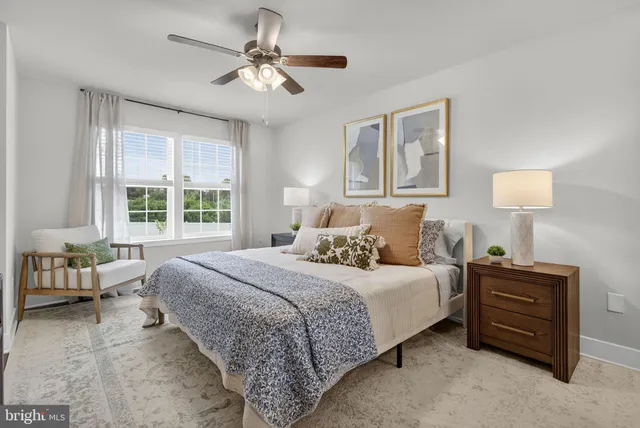 a bed room with a bed mirror and painting on the wall