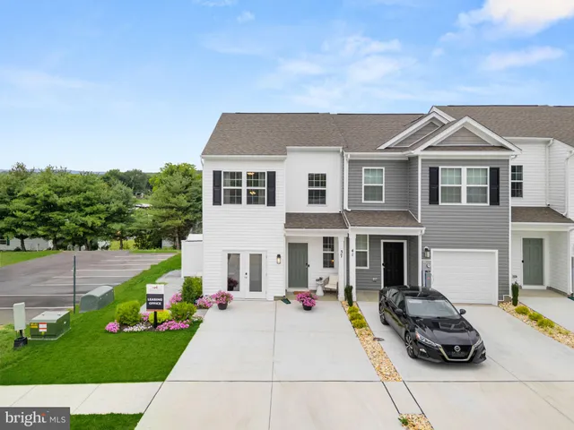 a view of a hallway with wooden floor and stairs