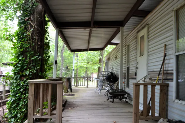 a view of a deck with wooden floor and outdoor seating