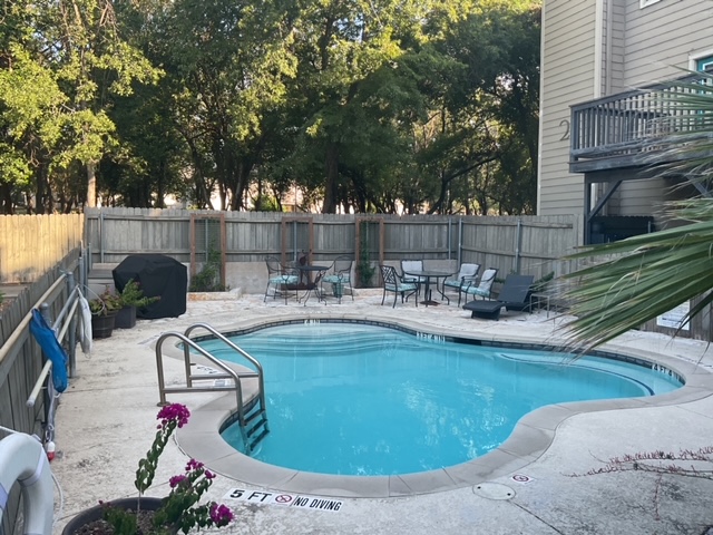 6700 Cooper Lane, Unit 40 Austin, TX 78745 - Photo 40 of 40 Community pool with a patio, a fenced backyard, and a grill
