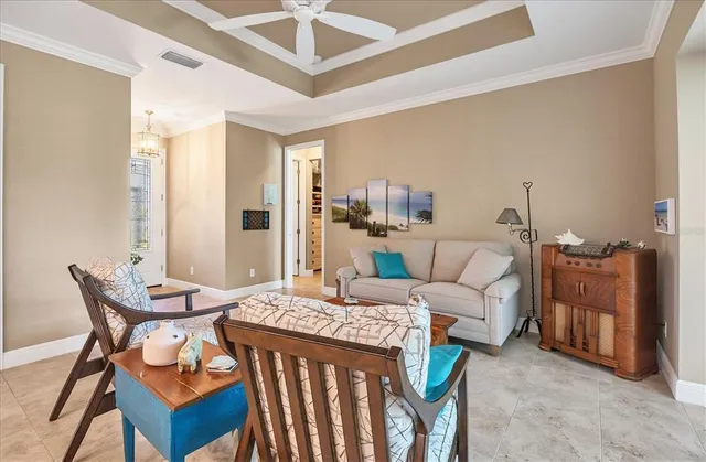a living room with furniture a fireplace and a chandelier