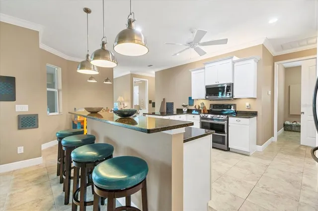 a kitchen with stainless steel appliances a stove a sink and a refrigerator