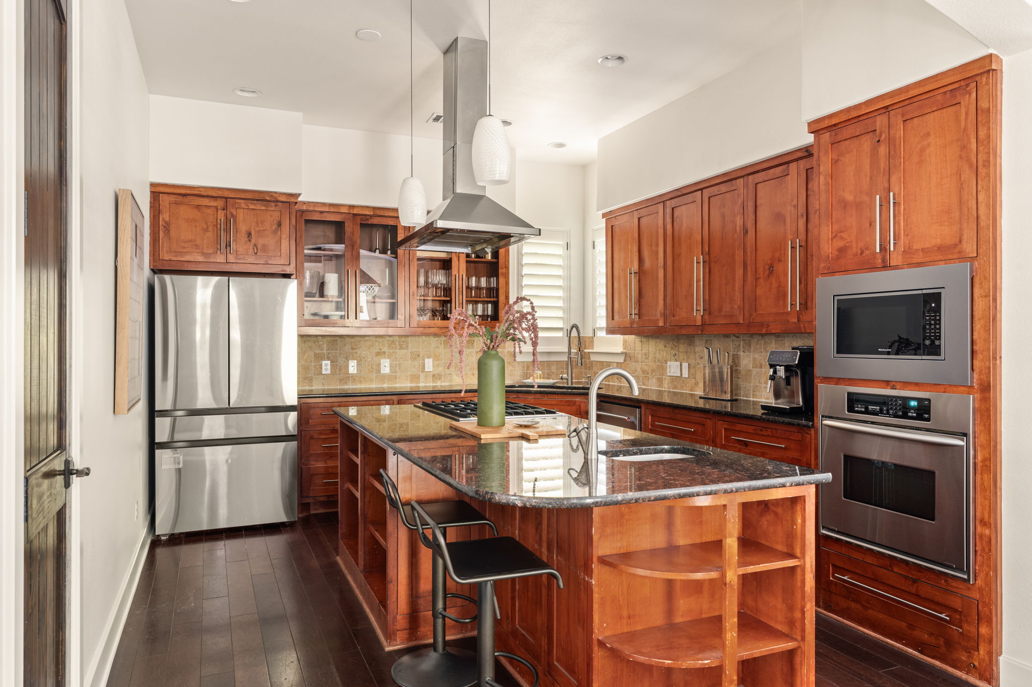2324 Kinney Road Austin, TX 78704 - Photo 10 of 35 Rich wood cabinets and a granite island highlight this beautifully crafted kitchen layout.