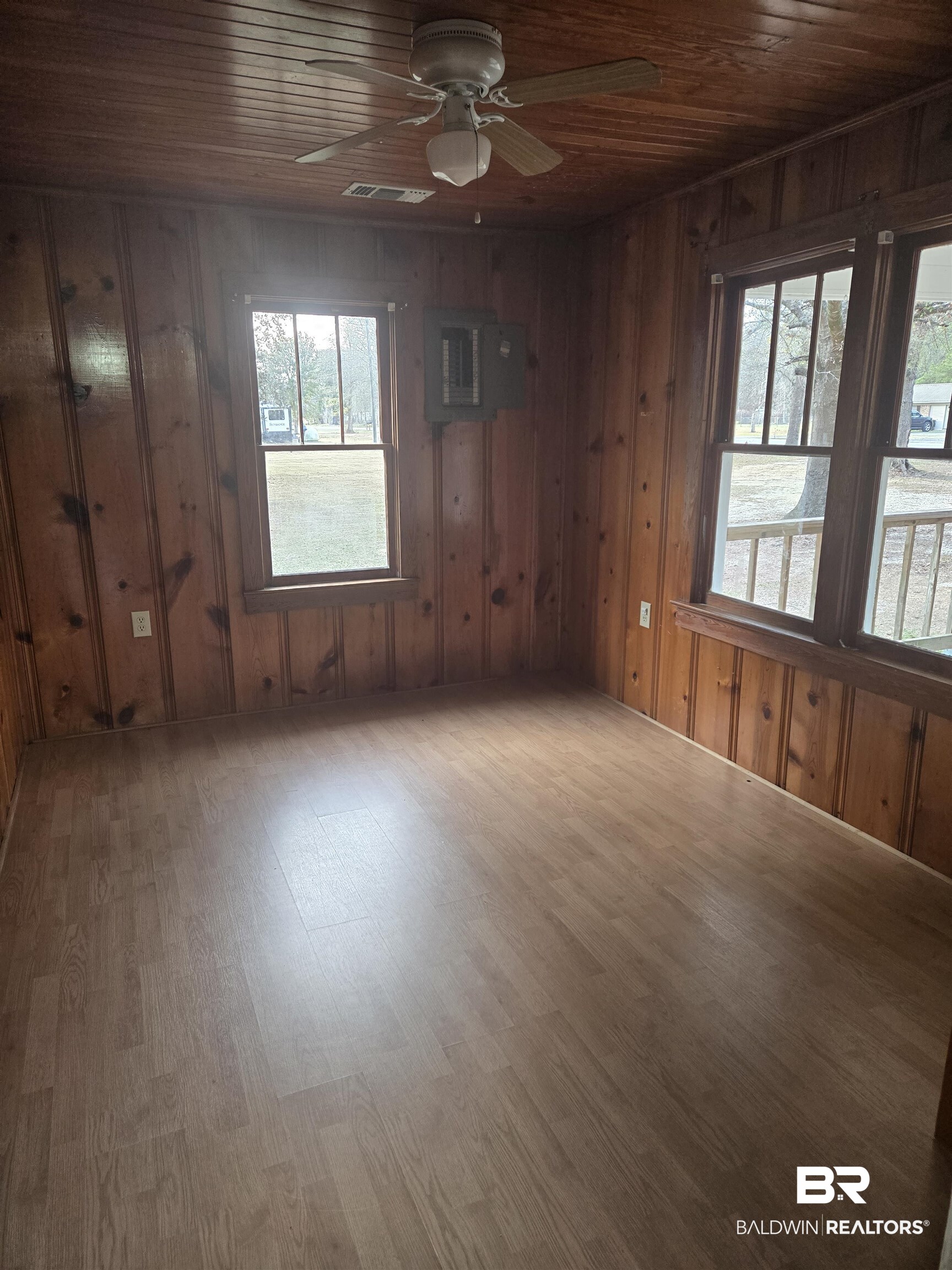 16360 Tolbert Road Bay Minette, AL 36507 - Photo 6 of 14 Empty room with wooden ceiling, wooden walls, wood finished floors, ceiling fan, and electric panel