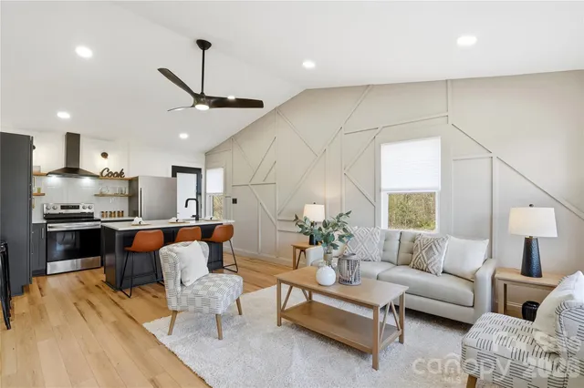 a living room with furniture and kitchen view