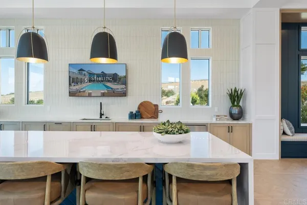 a large kitchen with stainless steel appliances lots of counter space and a sink