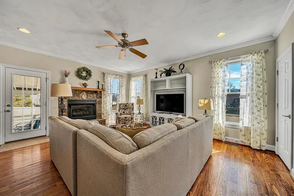 a kitchen with stainless steel appliances a dining table chairs stove refrigerator and cabinets