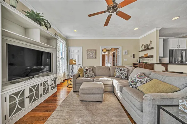 a large kitchen with stainless steel appliances a stove a sink a refrigerator and a center island