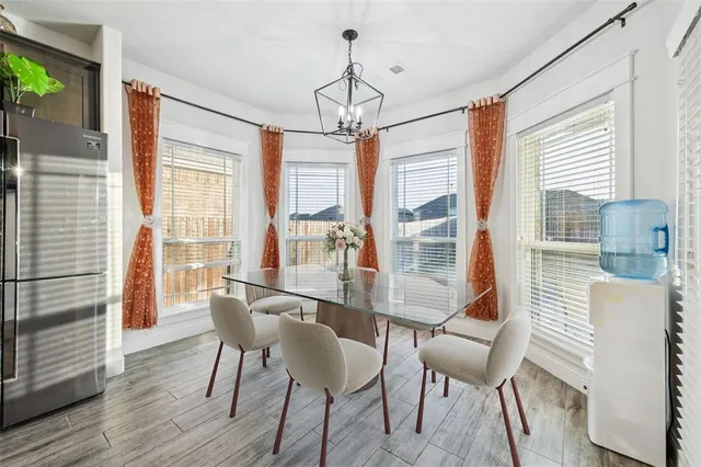 a view of a dining room with furniture windows and wooden floor