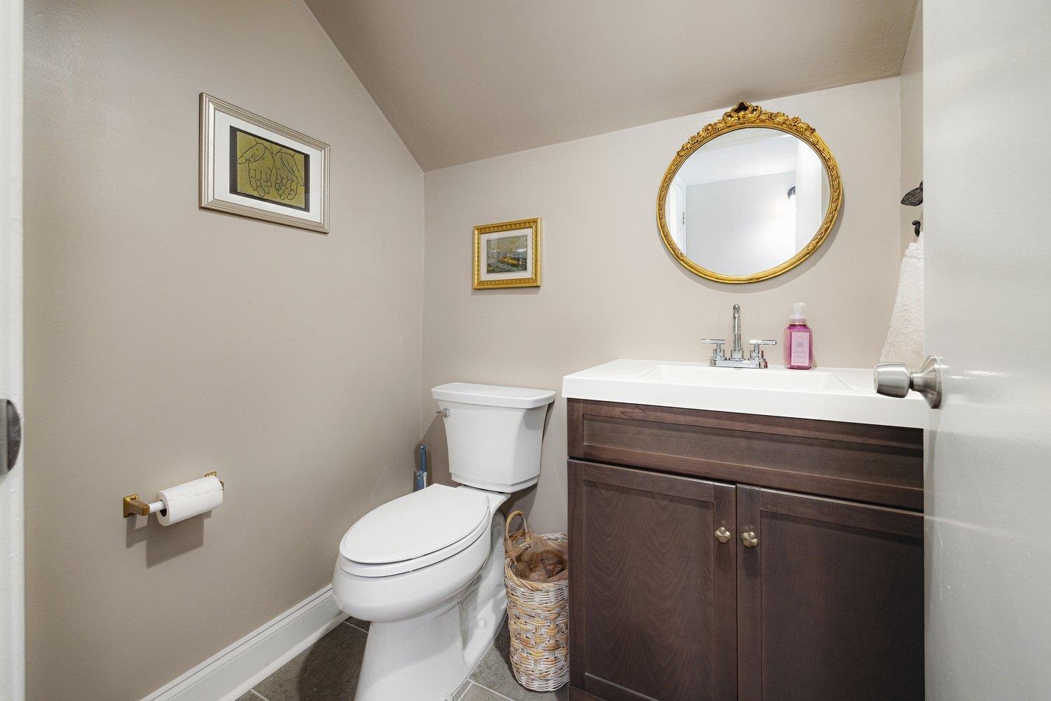 1005 June Road Memphis, TN 38119 - Photo 15 of 22 Bathroom featuring vanity, toilet, tile patterned floors, baseboards, and vaulted ceiling