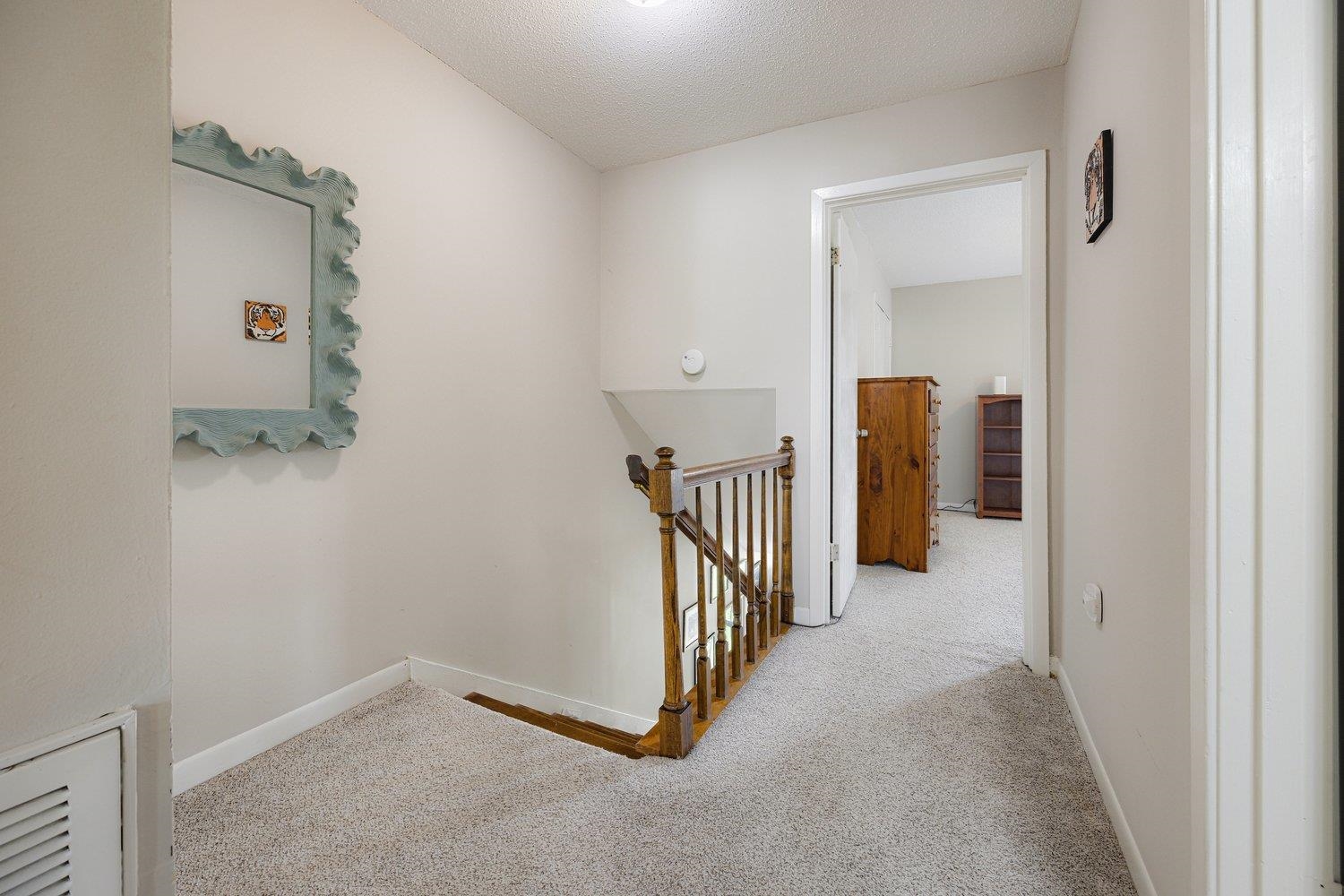 1005 June Road Memphis, TN 38119 - Photo 16 of 22 Hall with carpet floors, baseboards, and an upstairs landing