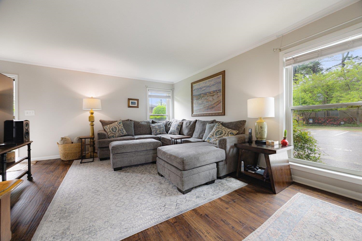 1005 June Road Memphis, TN 38119 - Photo 7 of 22 Living room with crown molding, baseboards, and dark wood-style flooring