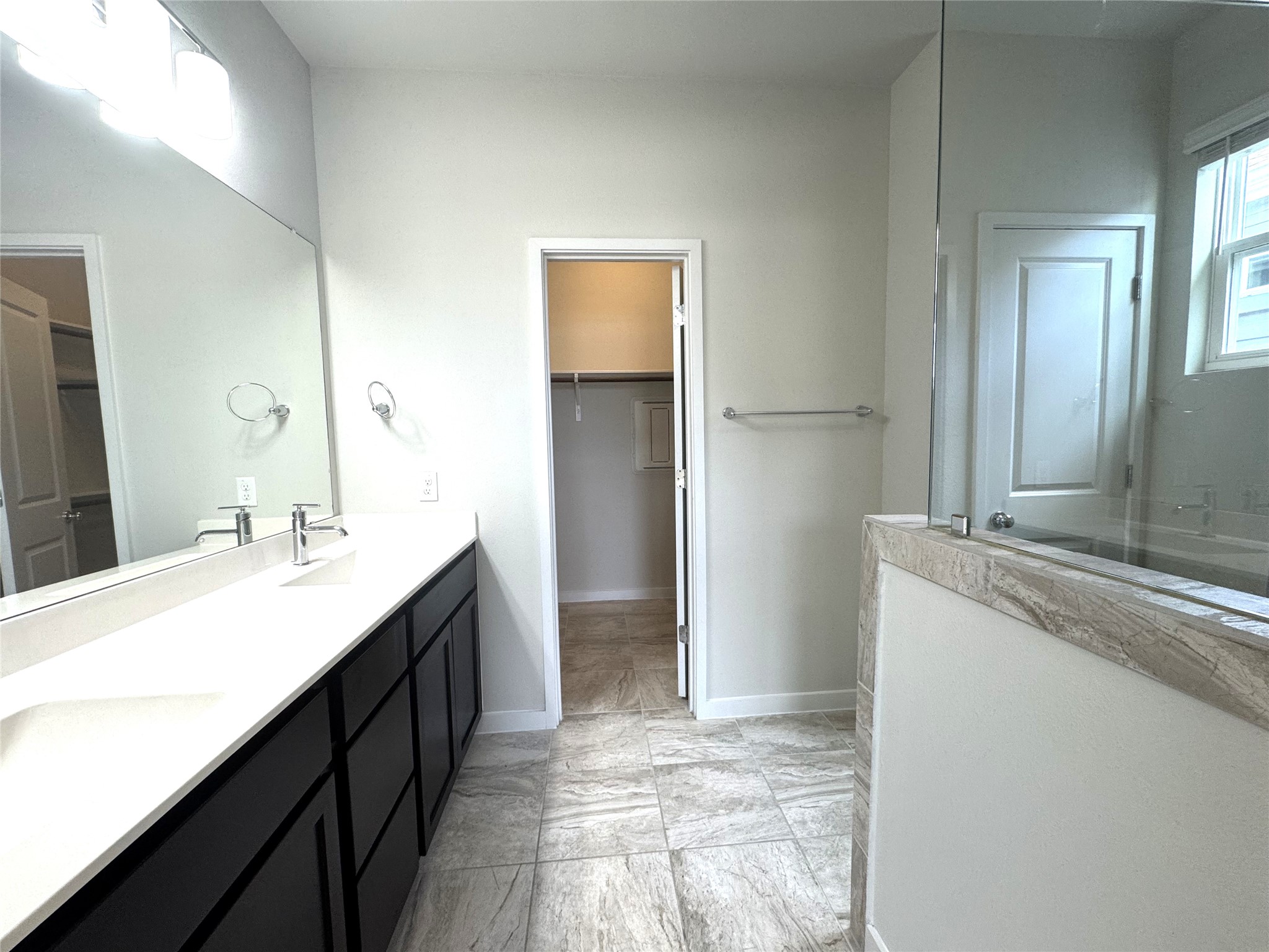 15102 Ryman Road Pflugerville, TX 78660 - Photo 11 of 12 a bathroom with a double vanity sink a and mirror
