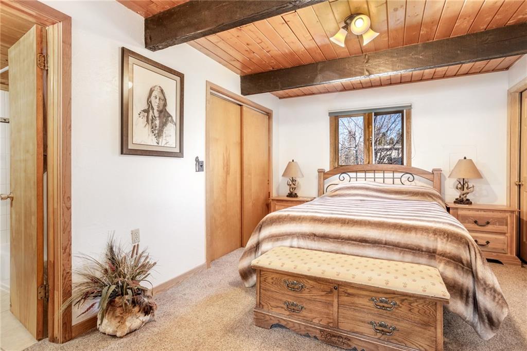 567 G Road Silverthorne, CO 80498 - Photo 17 of 32 a bedroom with a bed and a window