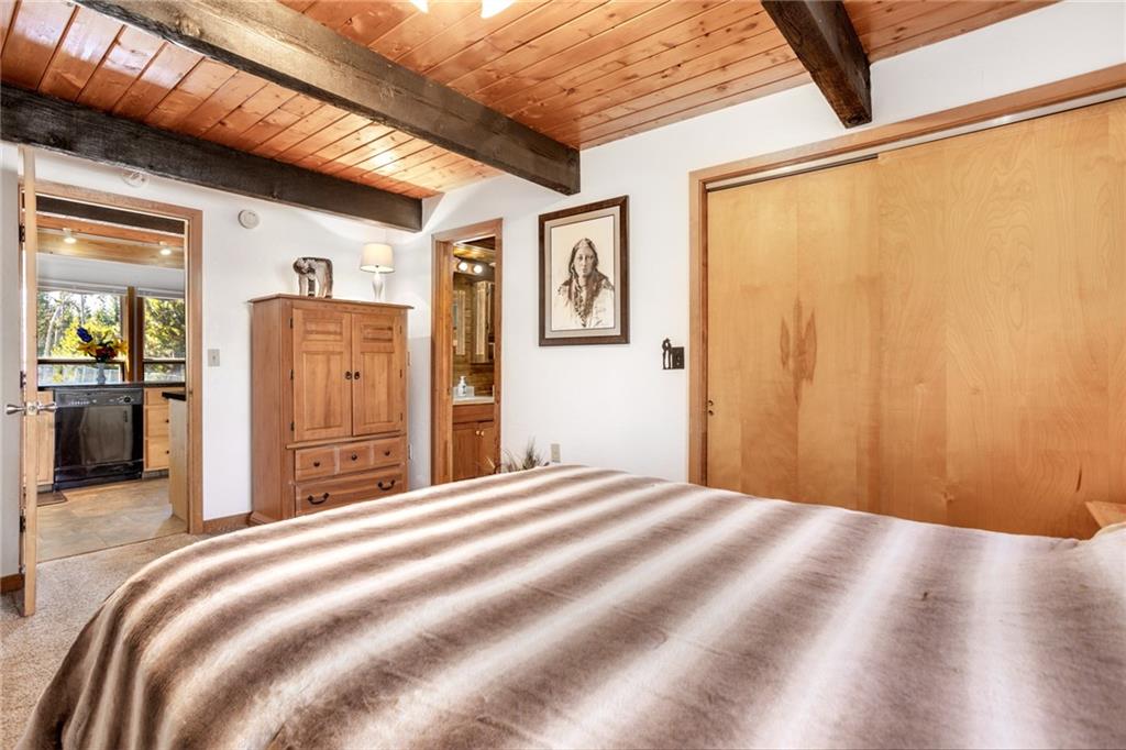 567 G Road Silverthorne, CO 80498 - Photo 18 of 32 a bed room with a bed and wooden floor