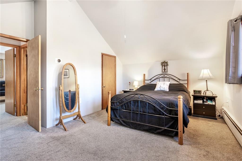 567 G Road Silverthorne, CO 80498 - Photo 21 of 32 a bedroom with a bed and a chandelier