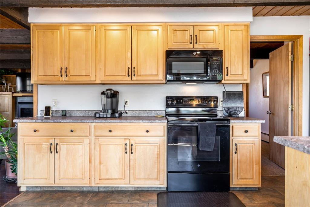 567 G Road Silverthorne, CO 80498 - Photo 10 of 32 a kitchen with stainless steel appliances granite countertop a stove a sink and a microwave