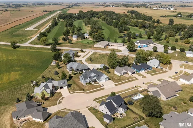 a view of a hallway with wooden floor and closet