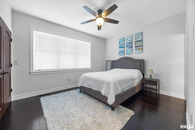 a dining room with wooden floor and a chandelier