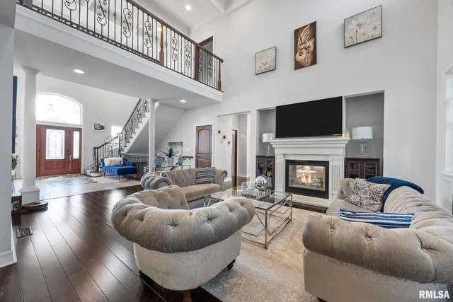 a living room with furniture and floor to ceiling windows