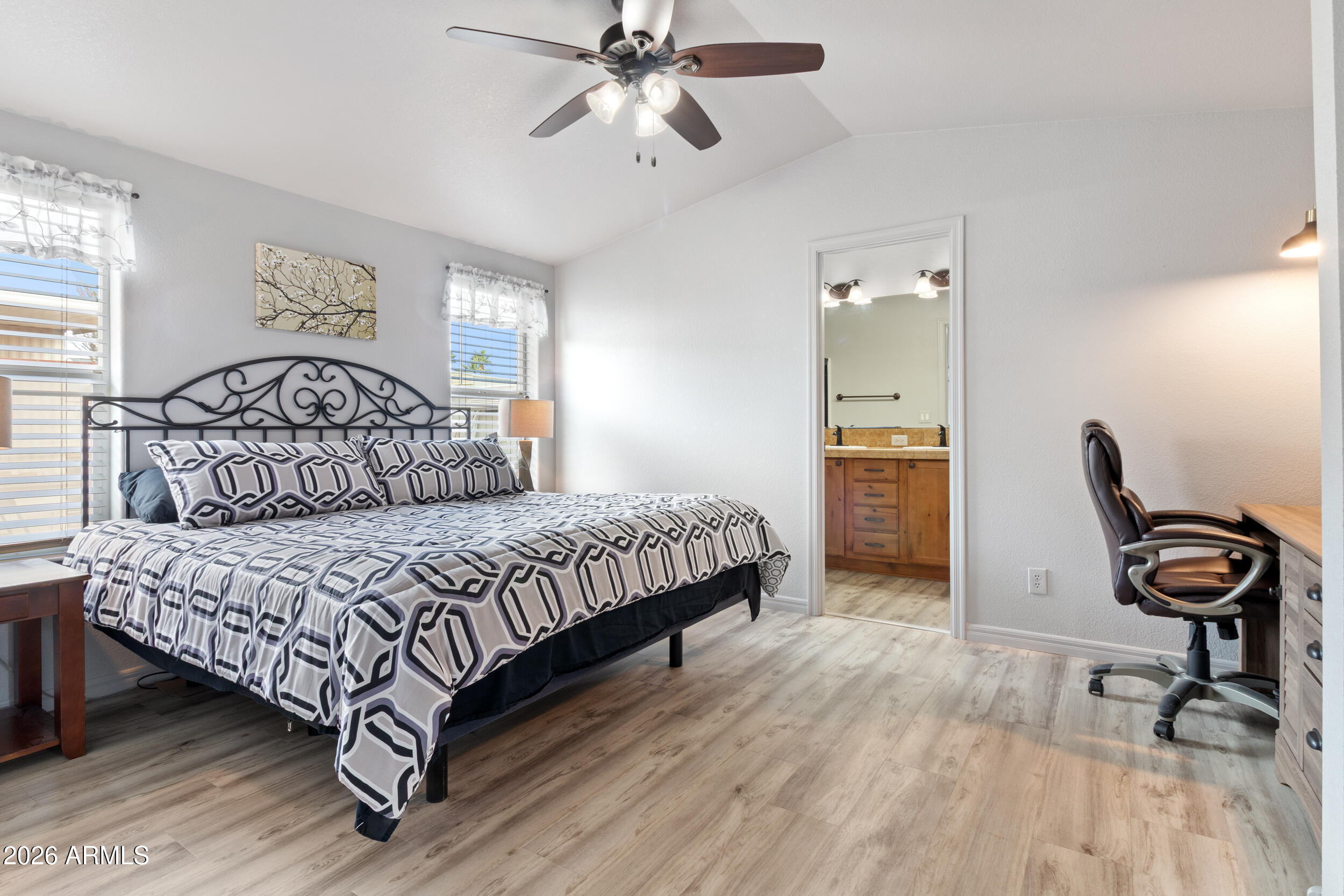 10936 East Apache Trail, Unit 121 Apache Junction, AZ 85120 - Photo 7 of 10 a bedroom with a bed a desk and chair