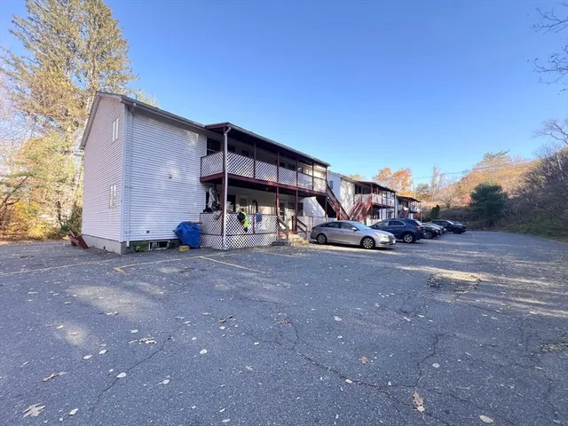 a wooden bench sitting in front of a building
