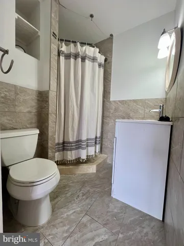 a bathroom with a toilet and a tub
