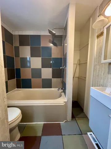 a bathroom with a toilet and a bathtub