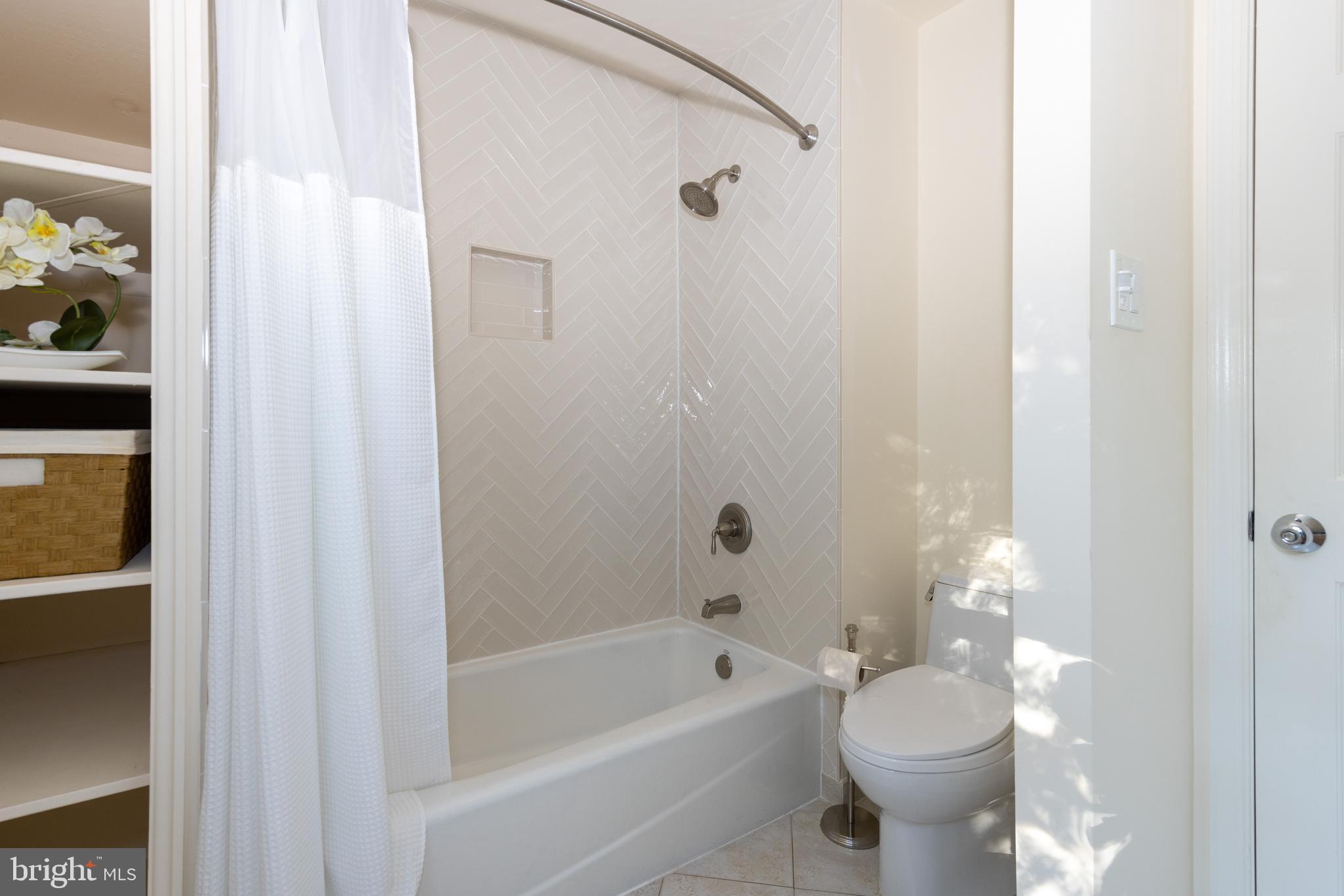 9702 Rambling Ridge Court Fairfax Station, VA 22039 - Photo 36 of 78 Hall bathroom with lovely new tile to the ceiling