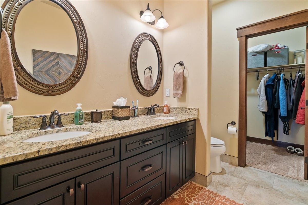 853 Independence Road, Unit 853 Keystone, CO 80435 - Photo 16 of 37 a bathroom with a granite countertop double vanity sink and a mirror