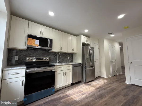 a view of room with wooden floor