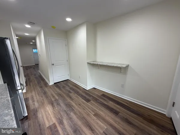 a view of a refrigerator in kitchen and wooden floor