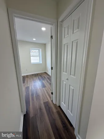 a view of an empty room and wooden floor