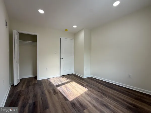 a view of hallway with wooden floor