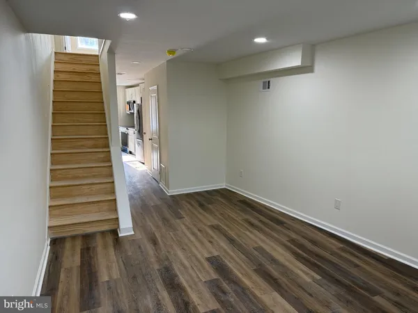 a view of a room with wooden floor and stairs