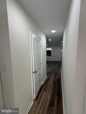 a view of a hallway view with wooden floor and staircase