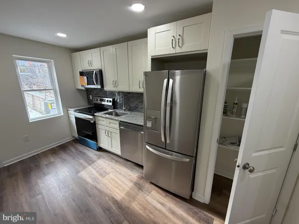 a view of room with window and wooden floor
