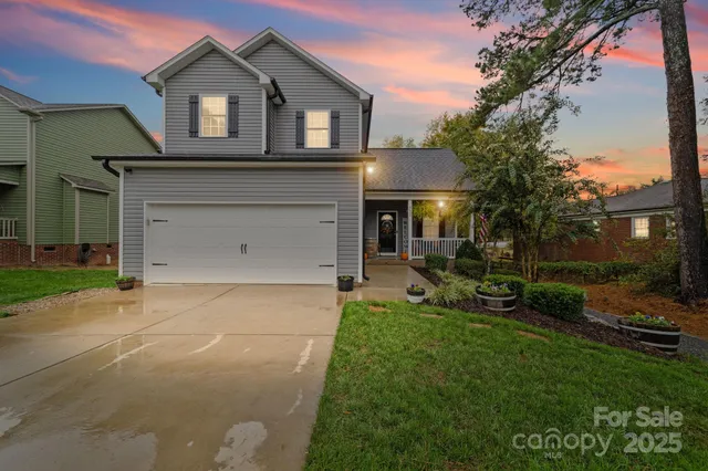 a front view of a house with a garden and yard