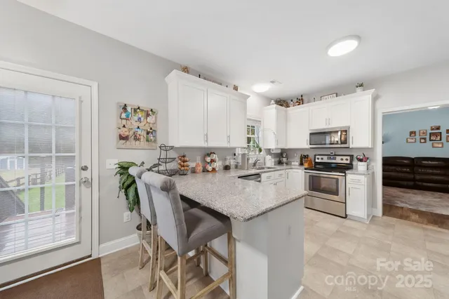 a kitchen with counter top space and living room