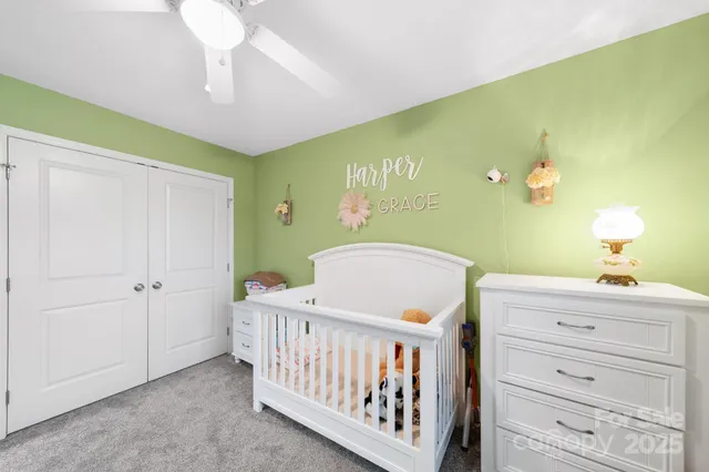 a bathroom with a granite countertop sink a toilet and a mirror