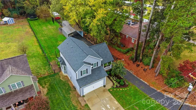 an aerial view of residential houses with outdoor space and swimming pool