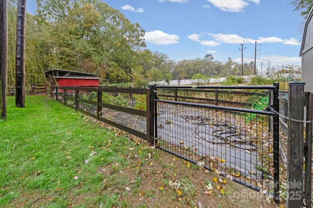 a view of a backyard with table and chairs with wooden fence