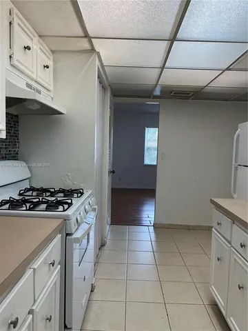 a kitchen with granite countertop a stove and a sink