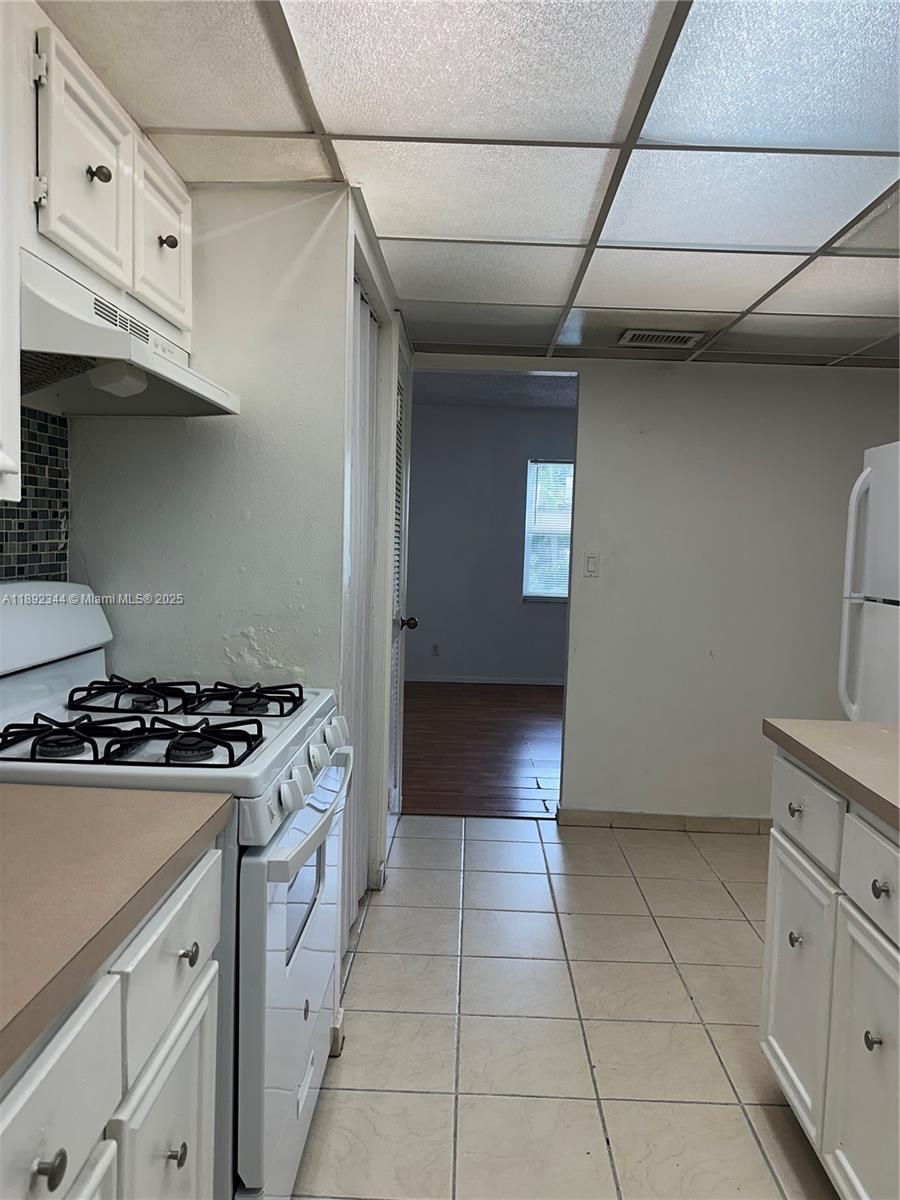 a kitchen with granite countertop a stove and a sink